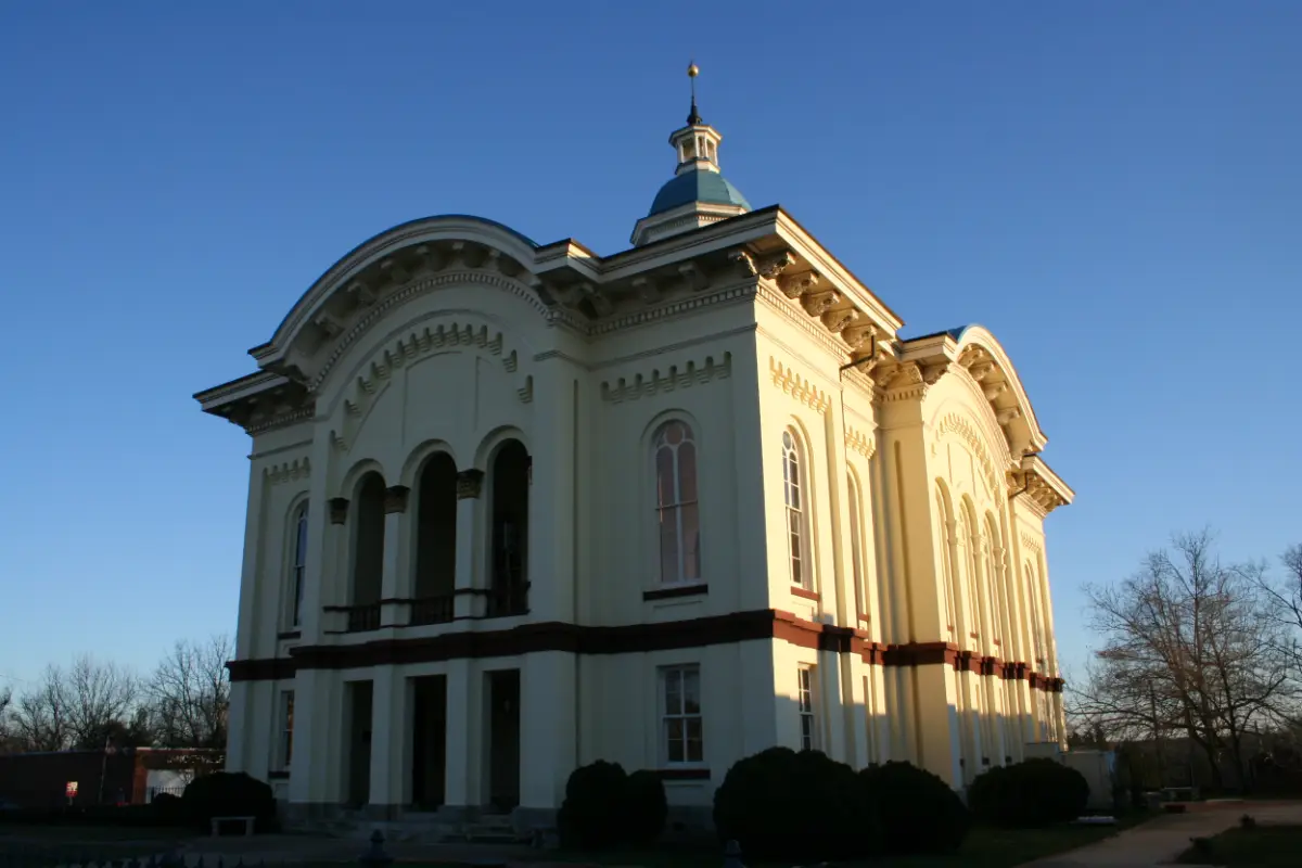 The Caswell County Courthouse in Yanceyville, North Carolina, under a blue sky